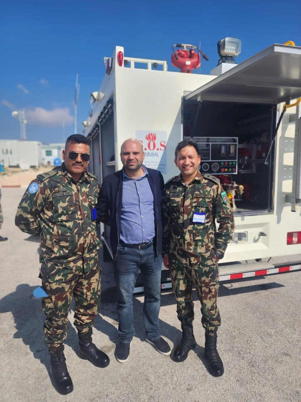 UN peacekeepers beside an S.O.S KIMIAL fire truck in South Lebanon